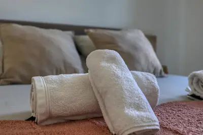 a pair of rolled up towels on a bed at Chez Valentina et Alexandre Port et plages à pied in Saint-Laurent-du-Var