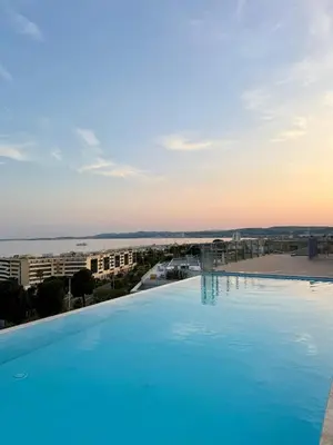 a large swimming pool with a view of a city at Chez Valentina et Alexandre Port et plages à pied in Saint-Laurent-du-Var