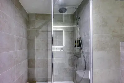 a shower with a glass door in a bathroom at Chez Valentina et Alexandre Port et plages à pied in Saint-Laurent-du-Var