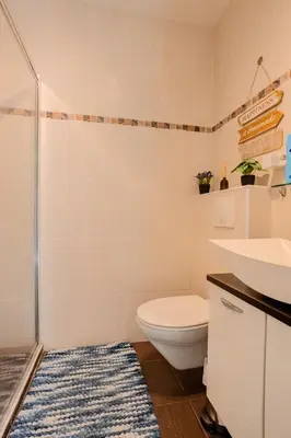 a bathroom with a toilet and a sink and a shower at Studio Terrace AC Lift - Old town | By Airnest in Nice