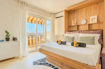 a bedroom with a large bed and a balcony at Studio Terrace AC Lift - Old town | By Airnest in Nice