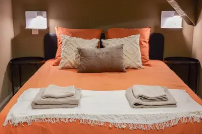 a bed with two towels and pillows on it at Extra Spacious Modern Apartment HUB Nice Center in Nice