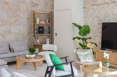 a living room with a couch and a tv at Extra Spacious Modern Apartment HUB Nice Center in Nice