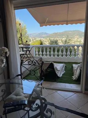 a patio with flowers on the side of a building at Villa Baie Des Anges in Nice