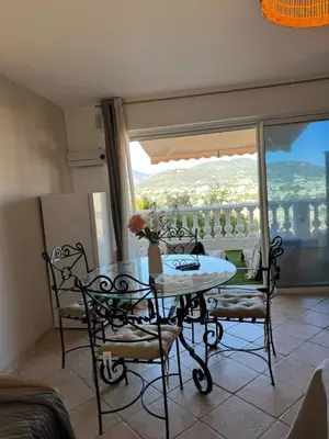 a chair sitting on a balcony with a view at Villa Baie Des Anges in Nice