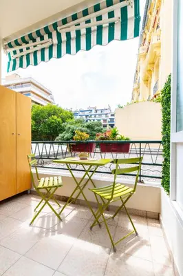 a table and chairs on a balcony with a view at Oasis Azur 1 min from the beach in Nice