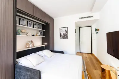a bedroom with a white bed with a black headboard at Oasis Azur 1 min from the beach in Nice