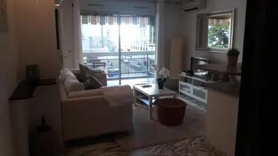a living room with a couch and a table at Baquis in Nice