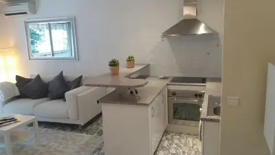 a kitchen and living room with a couch at Baquis in Nice