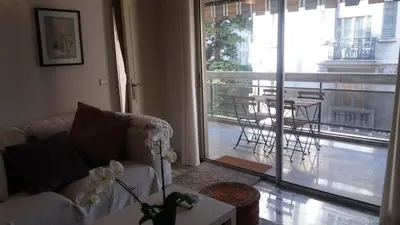 a living room with a couch and a large window at Baquis in Nice