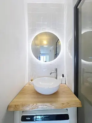 a bathroom with a bowl sink and a mirror at Studio Neuf avec Terrasse et Aperçu Mer in Nice