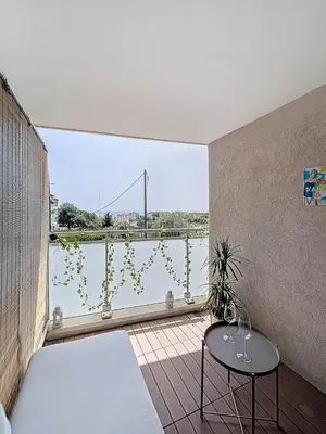 a room with a balcony with a view of the water at Studio Neuf avec Terrasse et Aperçu Mer in Nice