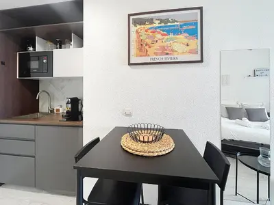 a black table with a hat on it in a kitchen at Studio Neuf avec Terrasse et Aperçu Mer in Nice