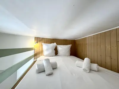 a bedroom with a large white bed with two pillows at C OT Maison de la Place - Old Town in Nice
