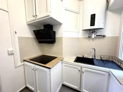 a kitchen with white cabinets and a sink at C OT Maison de la Place - Old Town in Nice