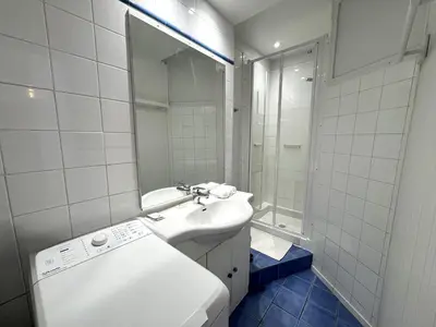 a white bathroom with a sink and a shower at C OT Maison de la Place - Old Town in Nice