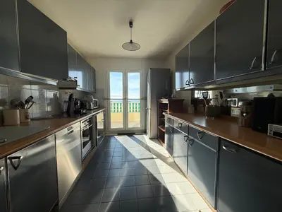 a kitchen with stainless steel appliances and a large window at 3 Pieces st laurent du Var in Saint-Laurent-du-Var