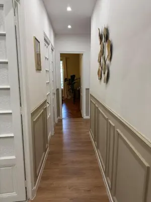 a hallway of a home with white walls and wood floors at Magnifique appartement dans palais Niçois in Nice