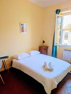 a bedroom with a bed with two slippers on it at Heart of city 62m2 in Nice