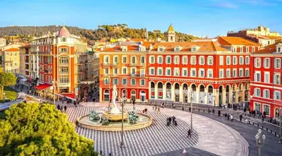 a city with a fountain in front of buildings at Heart of city 62m2 in Nice