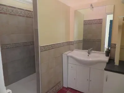 a bathroom with a sink and a mirror at Heart of city 62m2 in Nice