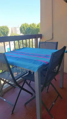 a blue table and chairs on a balcony at Apartment with balcony 5 minutes walk from the sea in Cagnes-sur-Mer