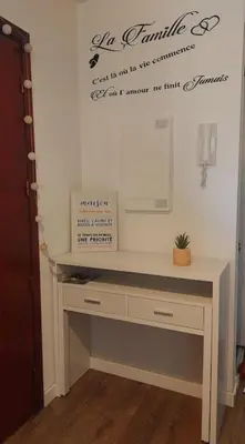 a desk in a room with a mirror on the wall at Apartment with balcony 5 minutes walk from the sea in Cagnes-sur-Mer
