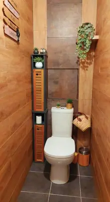 a bathroom with a toilet in a wooden wall at Apartment with balcony 5 minutes walk from the sea in Cagnes-sur-Mer