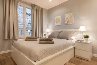 a bedroom with a large bed with two pillows on it at Le Comfy, cosy place dans le vieux nice avec climatisation in Nice