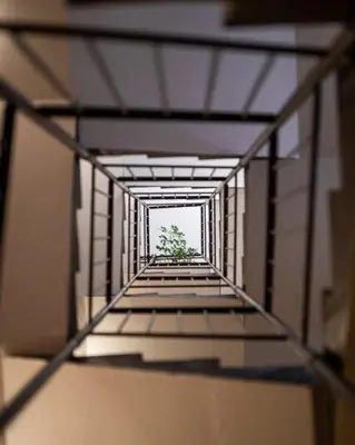 a view of a hallway with a tree in the distance at Le Comfy, cosy place dans le vieux nice avec climatisation in Nice
