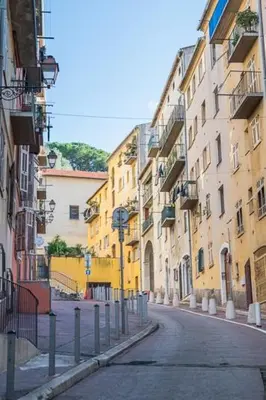 an empty street in a city with buildings at Le Comfy, cosy place dans le vieux nice avec climatisation in Nice