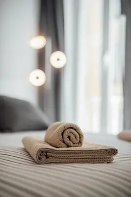 a towel sitting on top of a bed at Le Trendy, plein centre avec climatisation in Nice