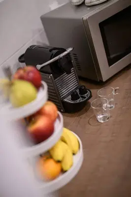 three bowls of fruit in front of a microwave at Le Trendy, plein centre avec climatisation in Nice