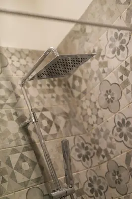 a shower with a shower head in a bathroom at L'Atelier, loft confortable dans la vieille ville, avec climatisation in Nice