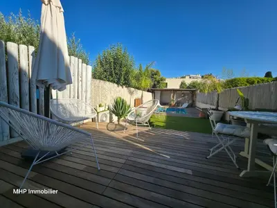 a swimming pool with a fence and blue water at La Palombière in Cagnes-sur-Mer