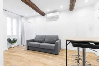 a living room with a couch and a table at Charmant petit 2 pieces dans la vieille ville in Nice