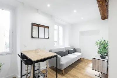 a living room with a couch and a table at Charmant petit 2 pieces dans la vieille ville - B in Nice