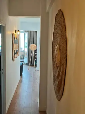 a surfboard hanging on a wall in a hallway at Votre grand COCON Niçois Appart Vue Mer in Nice