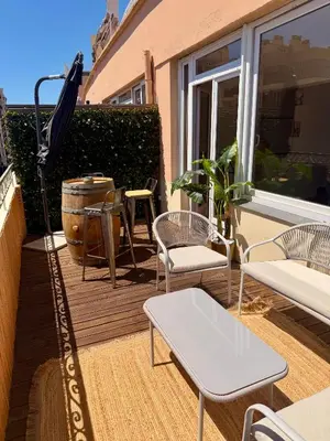 a patio with a table and chairs and an umbrella at Votre grand COCON Niçois Appart Vue Mer in Nice
