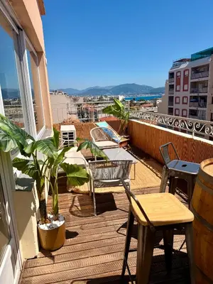 a balcony with chairs and tables on a building at Votre grand COCON Niçois Appart Vue Mer in Nice