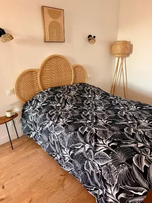 a bedroom with a bed with a black and white blanket at Votre grand COCON Niçois Appart Vue Mer in Nice
