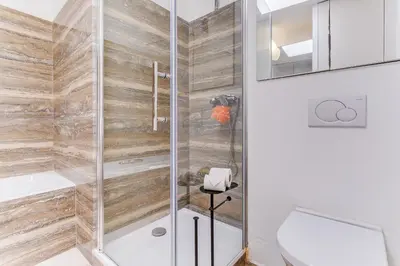 a shower with a glass door in a bathroom at PANORAMIC ESTEREL AP4475 By Riviera Holiday Homes in Villefranche-sur-Mer