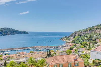 a view of a city and the water at PANORAMIC ESTEREL AP4475 By Riviera Holiday Homes in Villefranche-sur-Mer