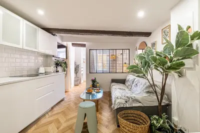 a living room with a couch and a table at Two suites with AC in the heart of Old Nice, each with its own entrance in Nice
