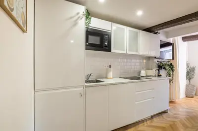 a white kitchen with a sink and a microwave at Two suites with AC in the heart of Old Nice, each with its own entrance in Nice