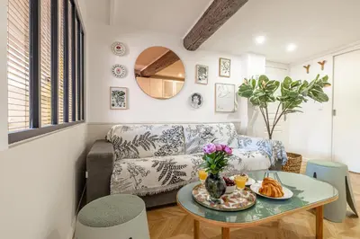 a living room with a couch and a table at Two suites with AC in the heart of Old Nice, each with its own entrance in Nice