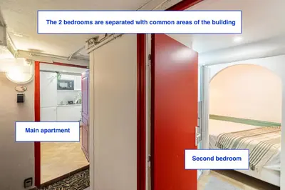 a room with a bed and a red door at Two suites with AC in the heart of Old Nice, each with its own entrance in Nice
