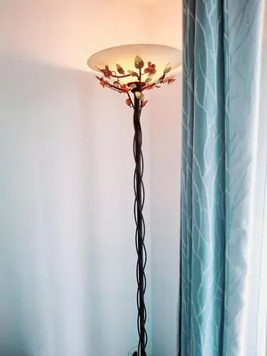 a floor lamp in a room with a blue curtain at T1 Bord De Mer Nice West in Nice