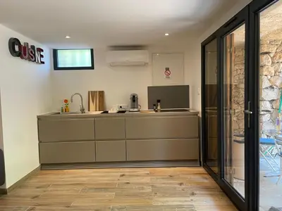 a kitchen with a sink and a counter at Le petit Baou in Saint-Jeannet