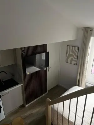 a bedroom with a bed and a large wooden door at Appartement confort au cœur de Nice in Nice